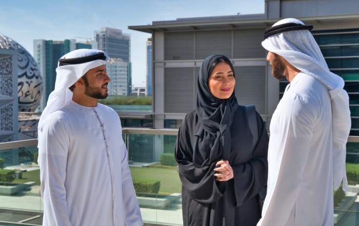 Emirati Gulf Arabs working outside the company's headquarters, touring abroad, general talks, work discussions, co-workers, business meeting in the open air